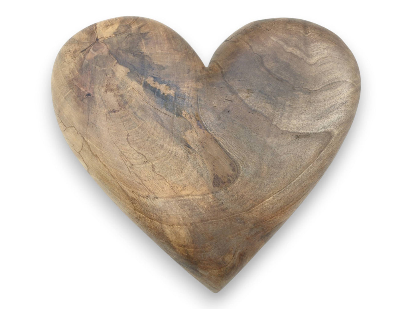 An overhead view of a carved timber heart reveals concentric growth rings and dark figuring.