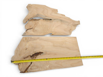 Two irregularly shaped alder wood pieces, with a yellow tape measuring the width of the bottom one.