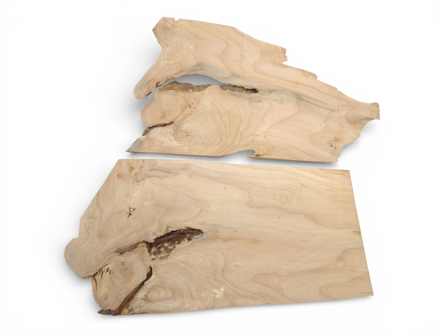 An overhead photograph of two light-toned alder slabs with organic live edges and visible knots.
