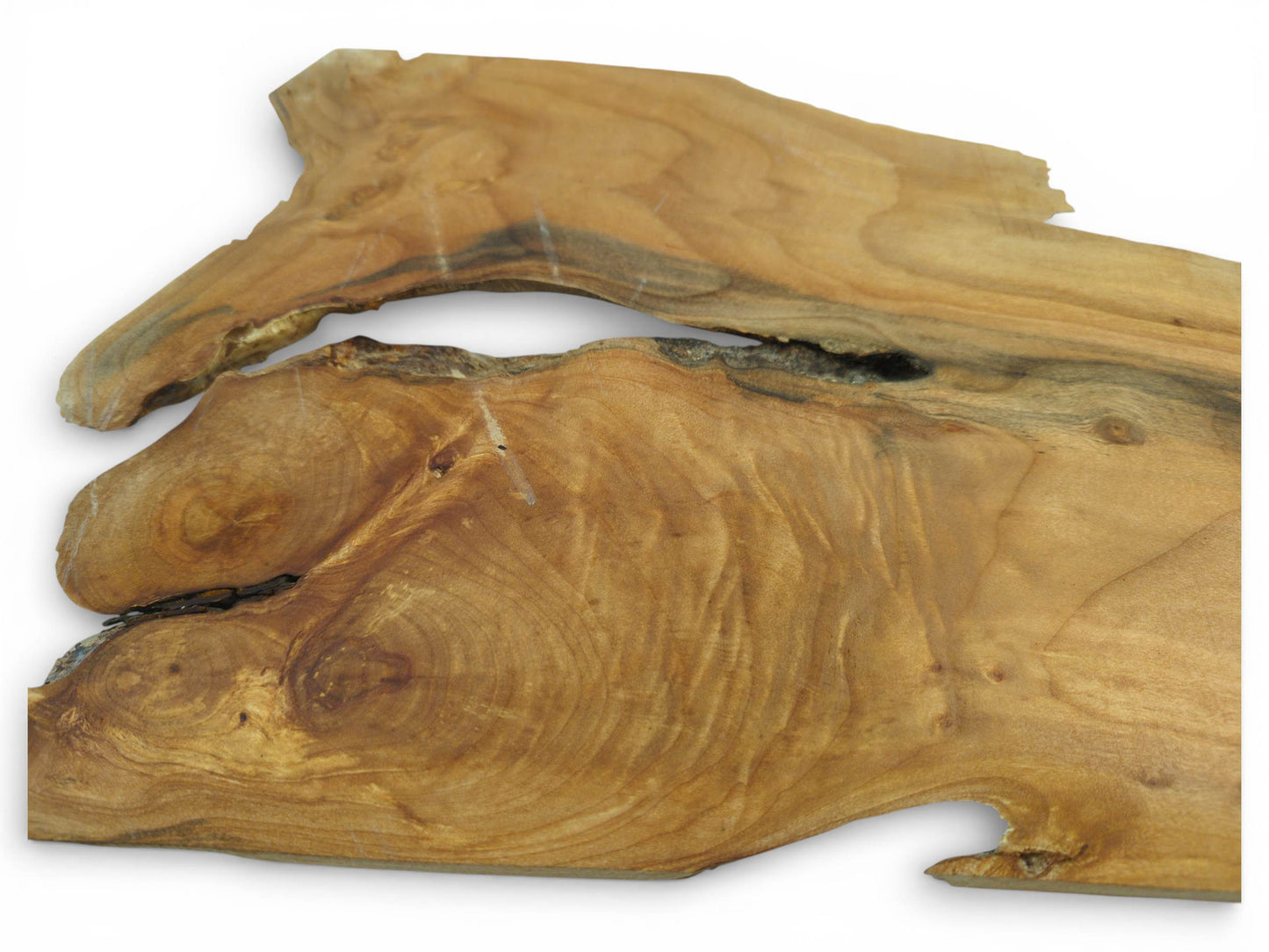 An angled shot of two stacked alder slabs, displaying their golden tones and intricate, swirling grain.