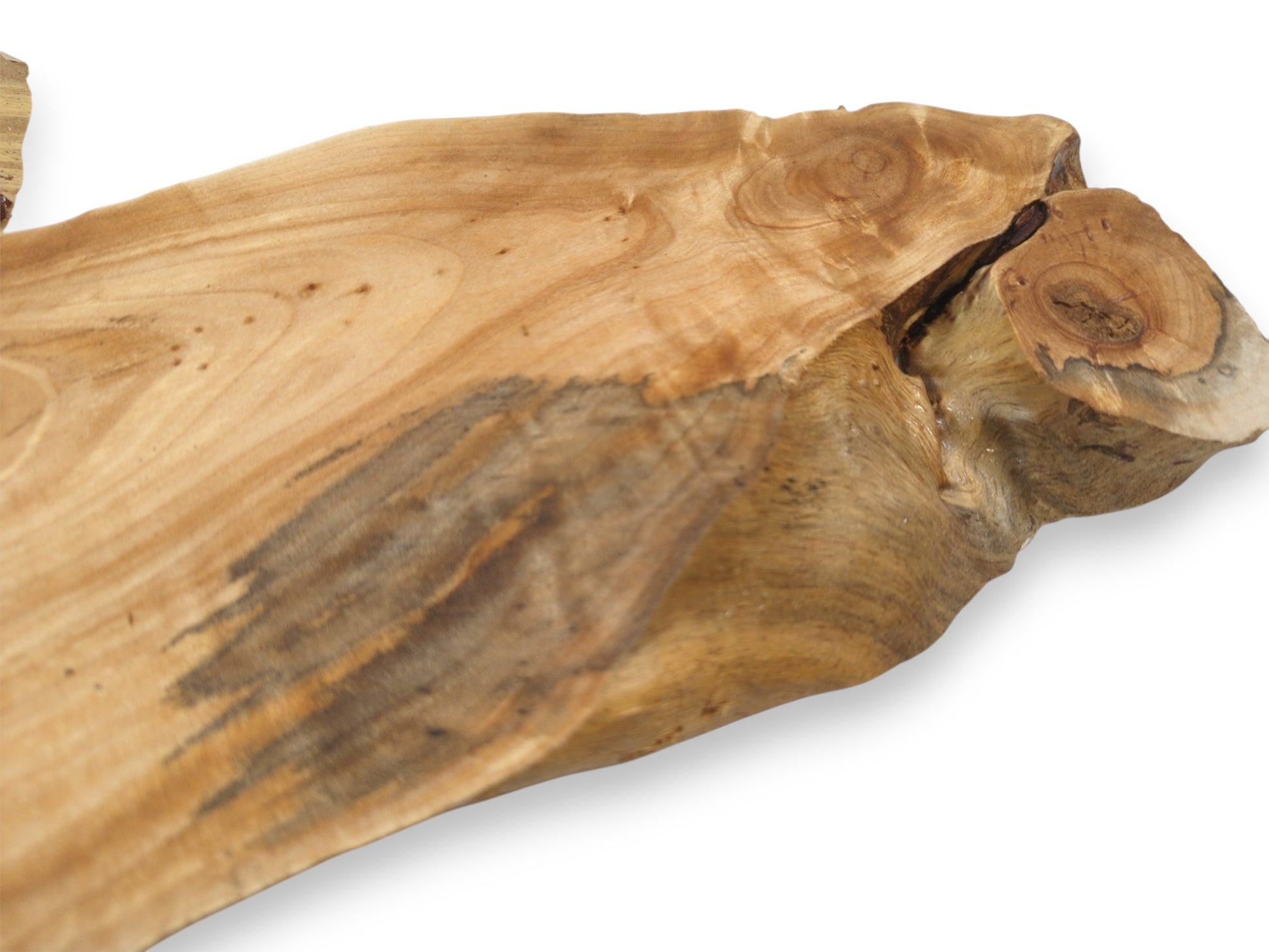 A dark, spalted grain pattern streaks across a smooth alder slab with a knotty burl.