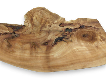 A low-angle shot captures the contoured grain and dark, cavernous knots of a timber section.