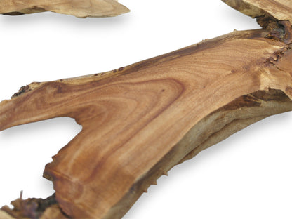Sweeping grain contours across a smooth timber slab, revealing a jagged, natural live edge.