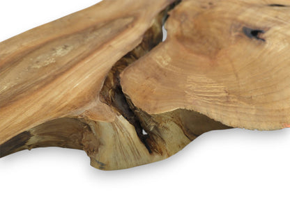 A deep, shadowy canyon cuts across a smooth timber plank with sweeping golden grain.