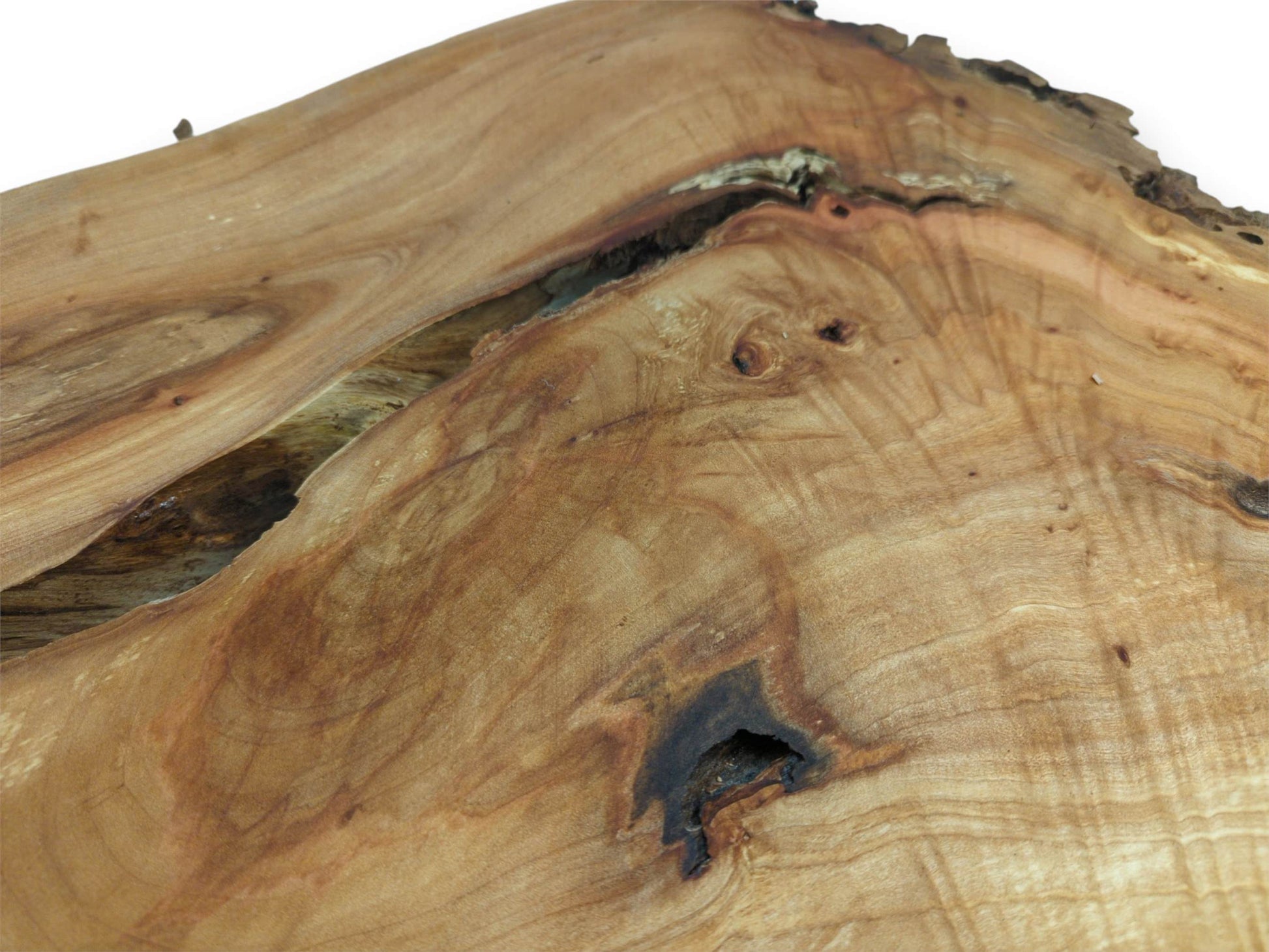 A dark, cavernous knot and a wide crevasse mark this plank's rippling golden surface.