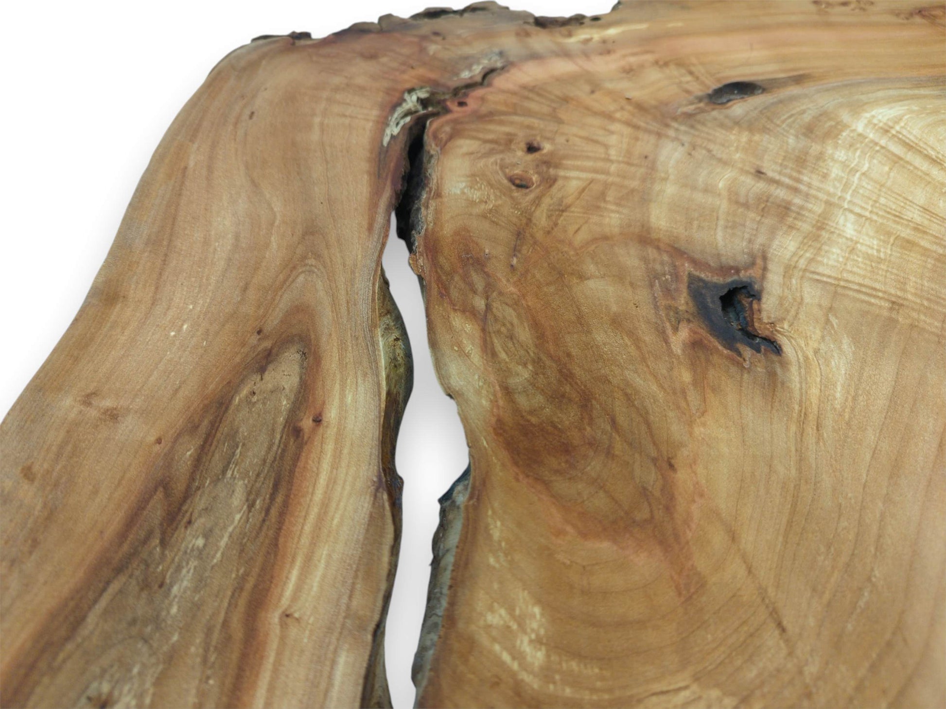 A deep, dark chasm splits a lumber slab with swirling grain and a pitted knot.
