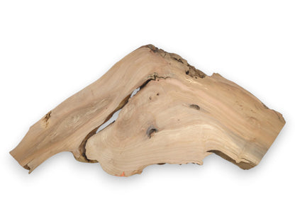 A pale, mountain-shaped alder plank features a deep fissure, swirling grain, and a rugged live edge.