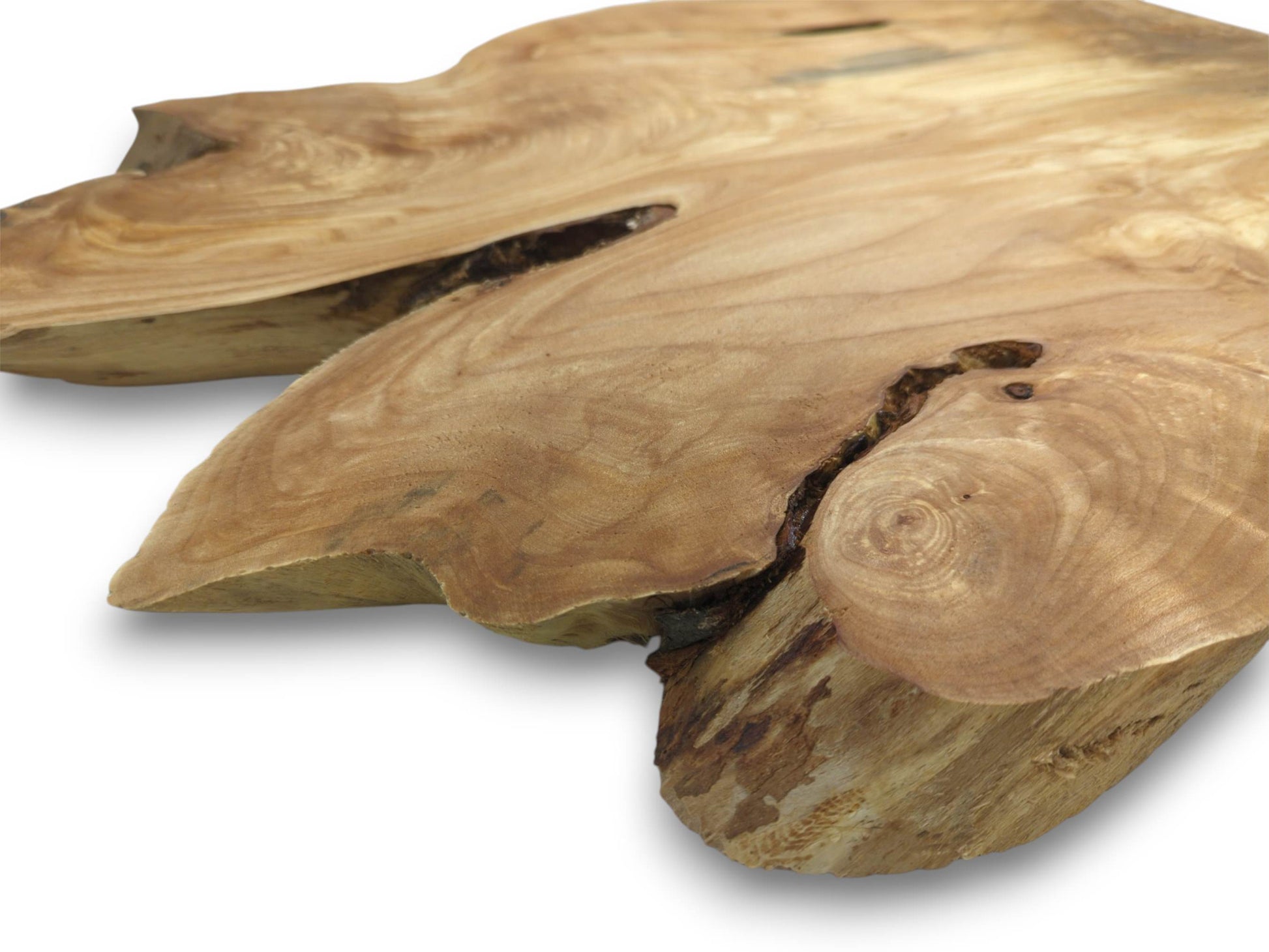 A thick, sanded wood piece features circular grain patterns next to a deep, dark fissure.