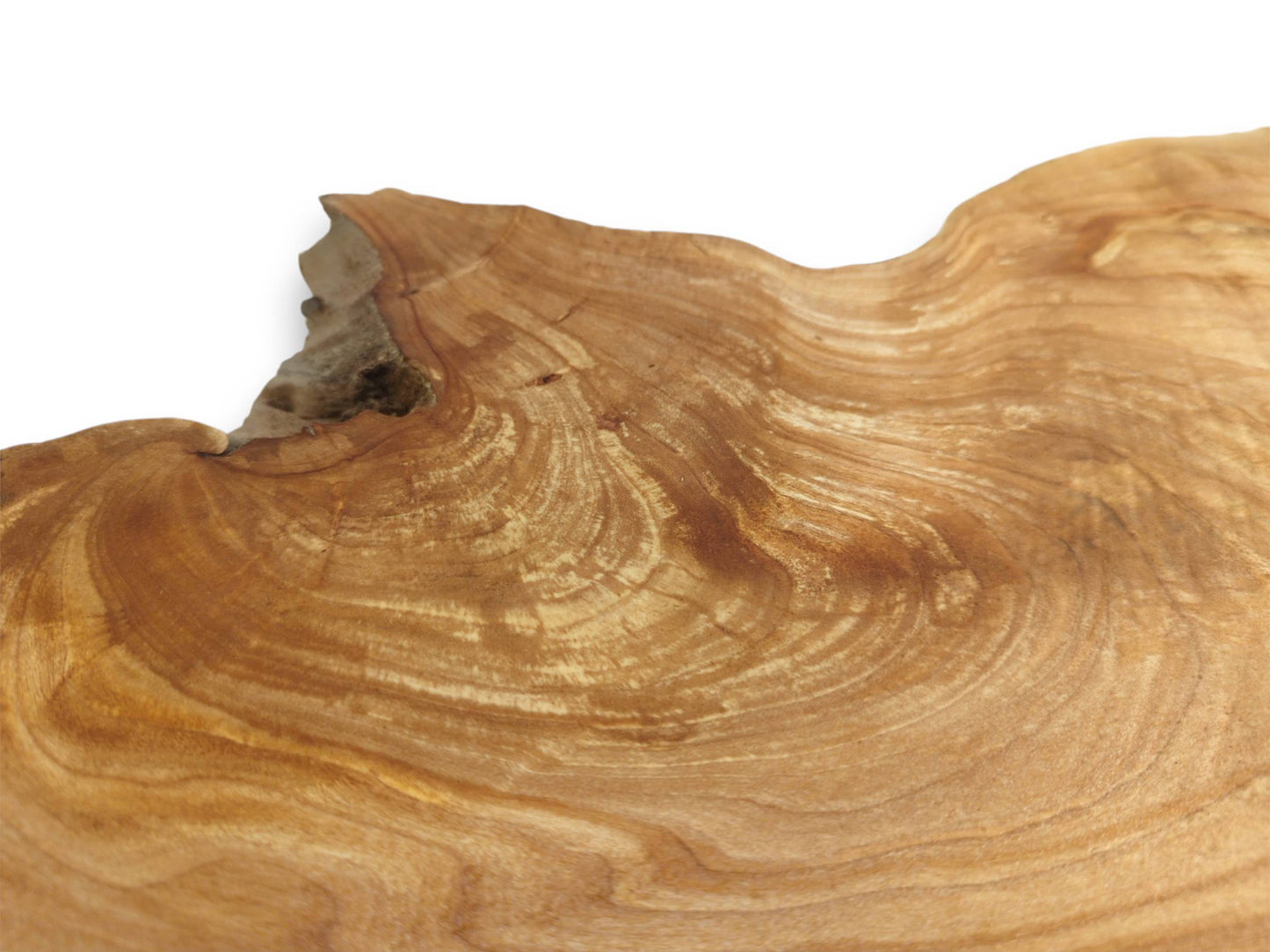 Golden-hued lumber displays sweeping, contoured grain patterns that curve toward an uneven edge.