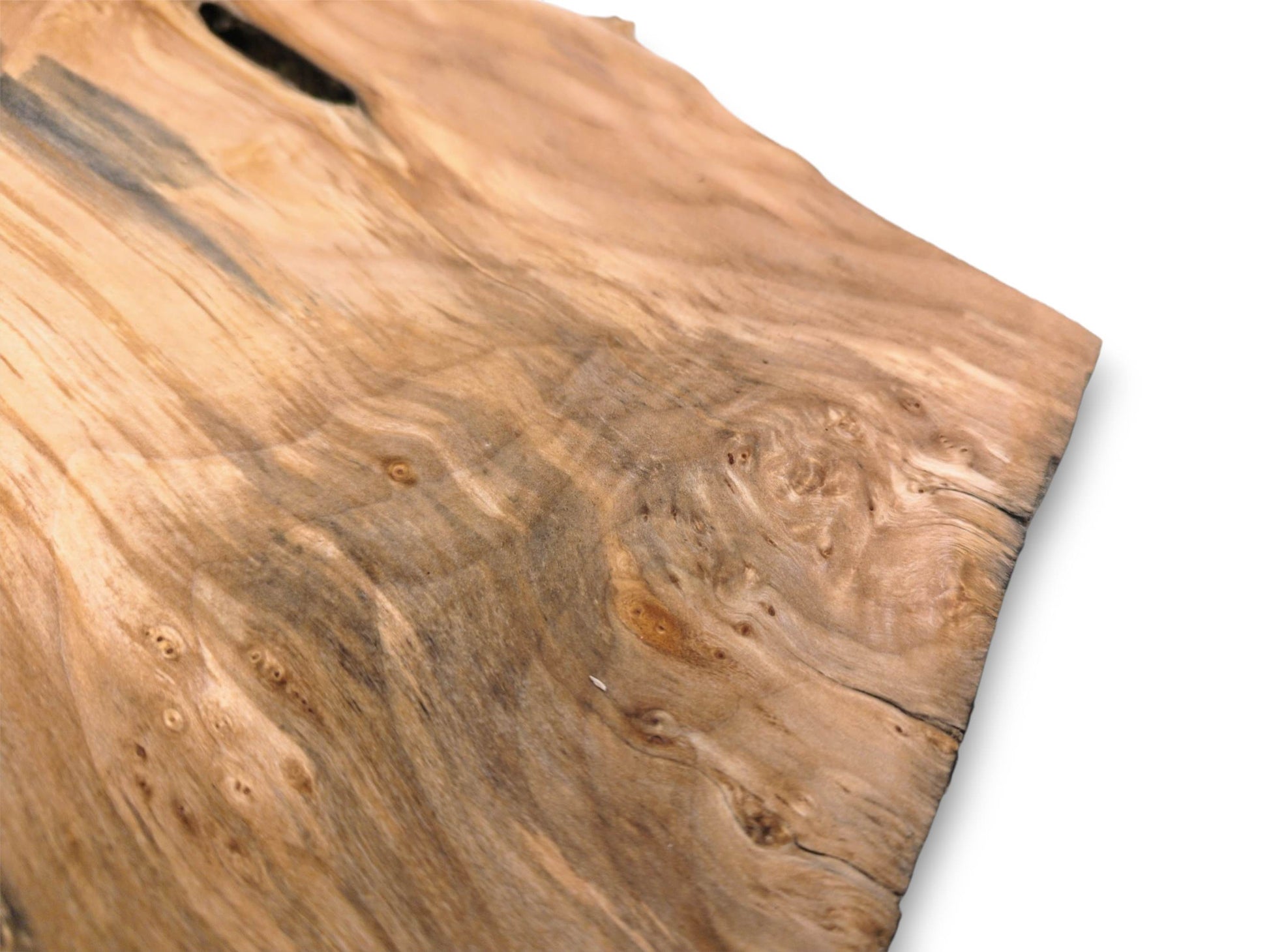 A timber piece shows grey mineral stains flowing through swirling burl patterns and small knots.