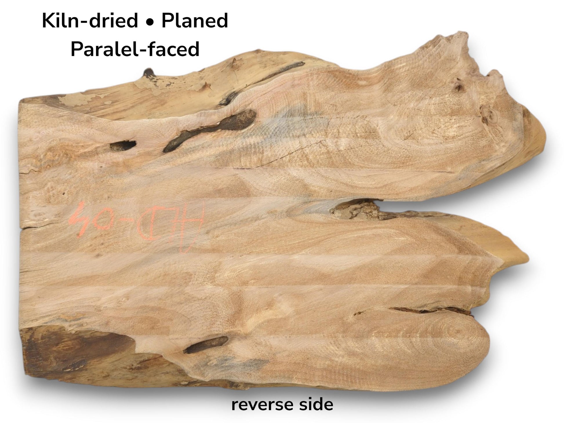A planed lumber section with a wide central fissure, dark voids, and wavy grain.