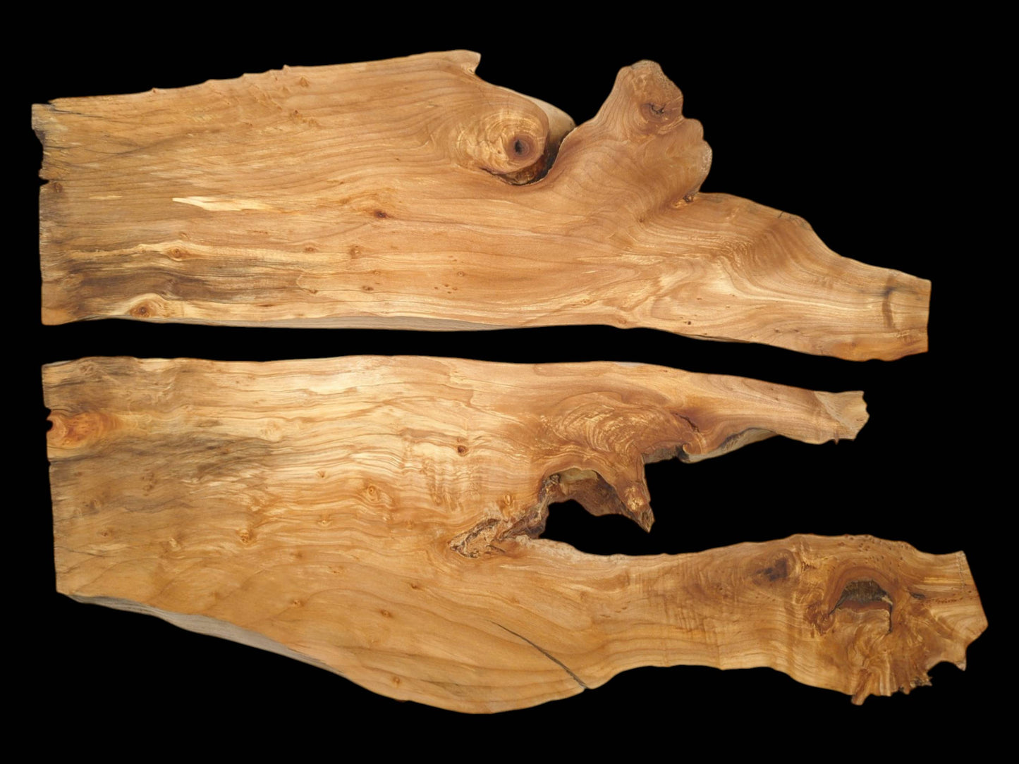 Two horizontal lumber planks feature organic contours and warm, wavy figuring with circular knots.