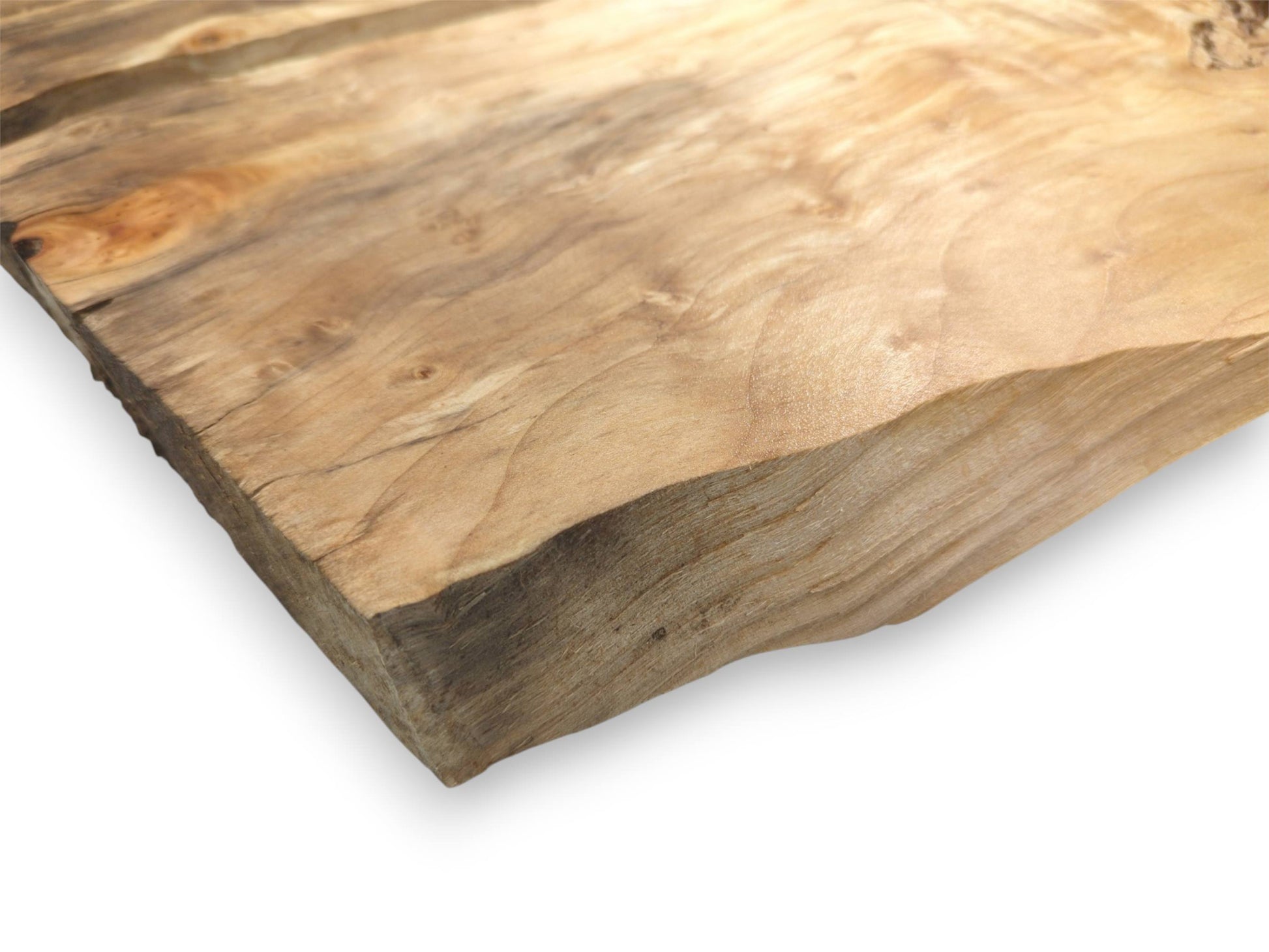 A thick timber corner displays a smooth, lustrous surface above a rough, unfinished live edge.