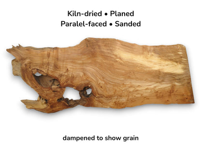A gnarled timber slab with a cavernous live edge and dramatic, flowing grain patterns.