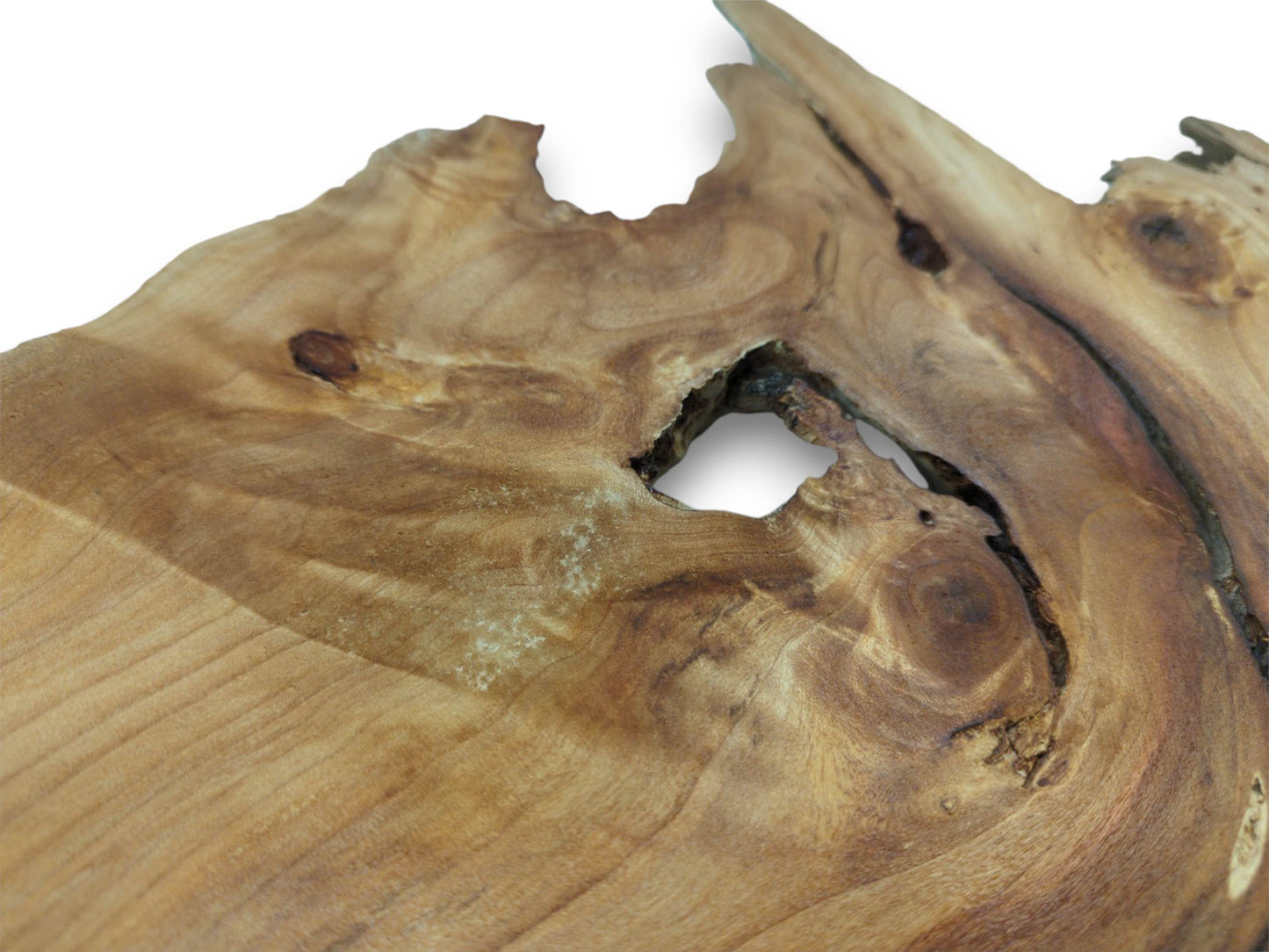 A close-up of a smooth wood surface with a central aperture and grain flowing around it.