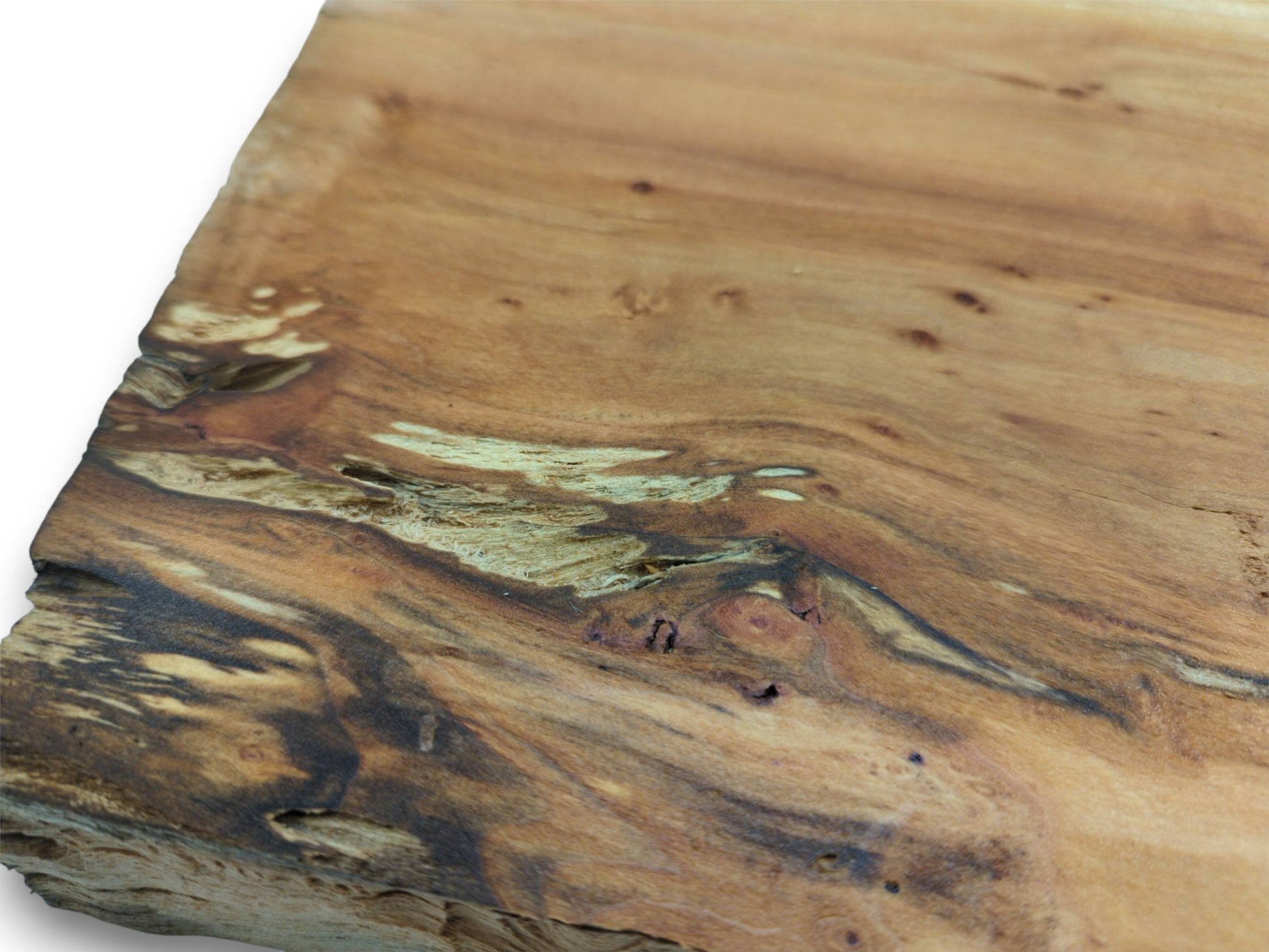 A close, angled view of a timber slab with dark, flowing grain and fibrous cavities.