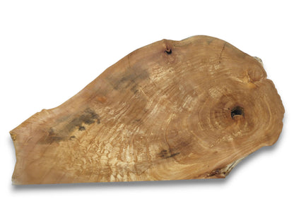 An irregular timber slab shows swirling grain, a dark central void, and mottled patterns.
