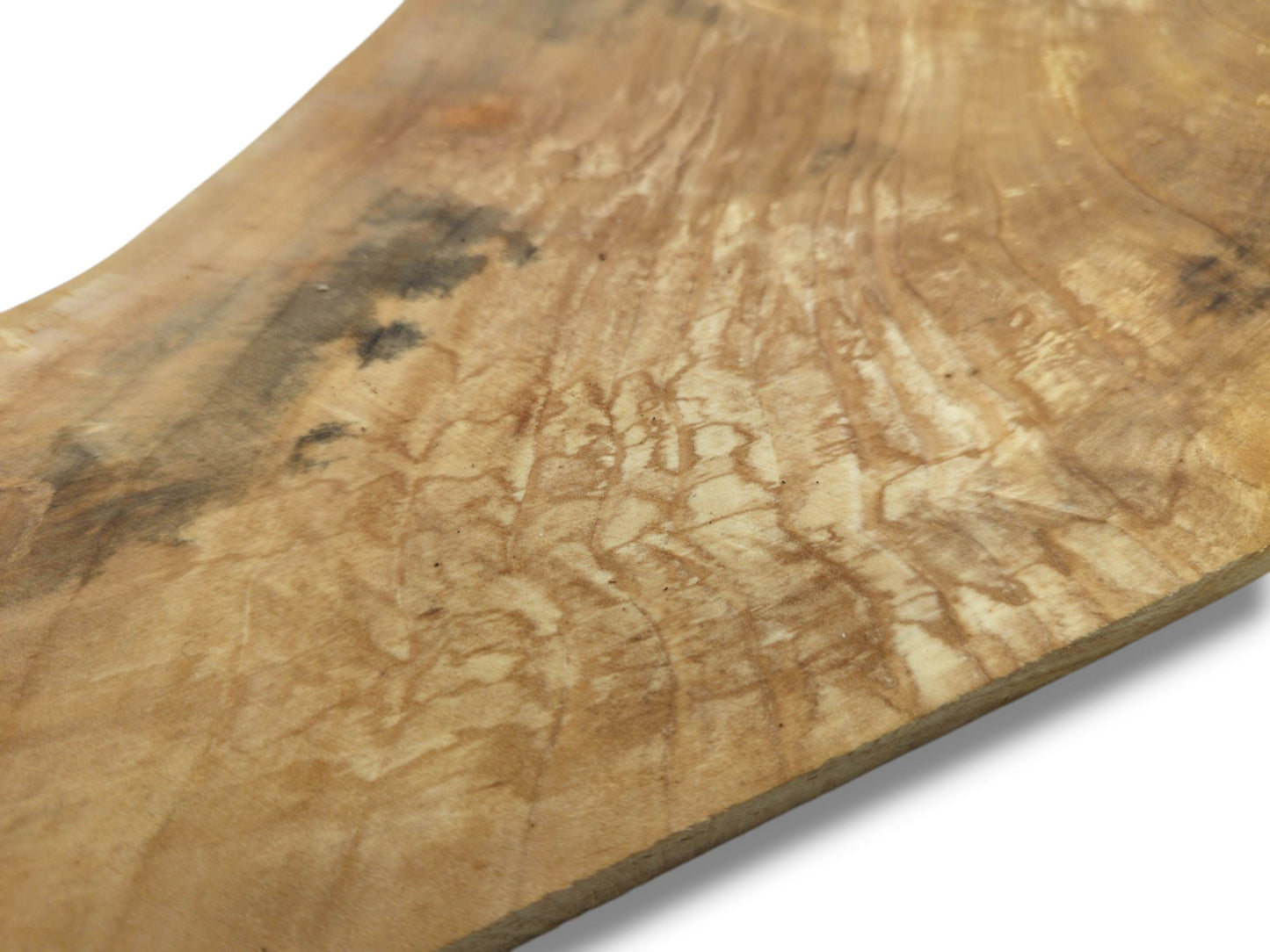 A pale timber slab shows intricate, spalted figuring and dark, shadowy mineral stains.
