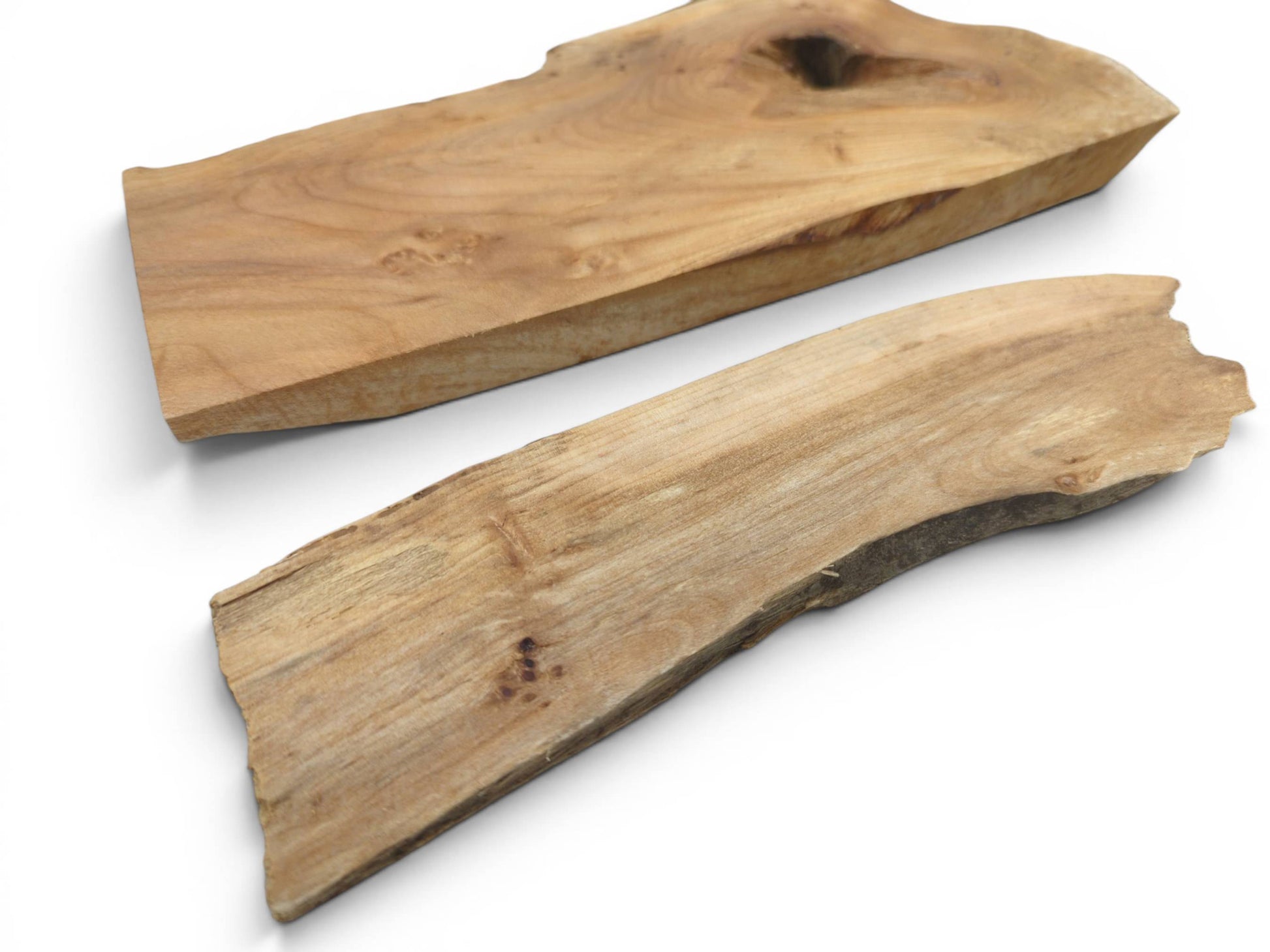 Two light brown alder wood slabs with natural live edges on a white background.