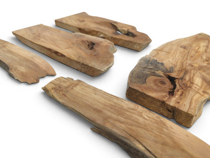 Five natural alder wood slabs with live edges, prominent knots, and varied wood grain.