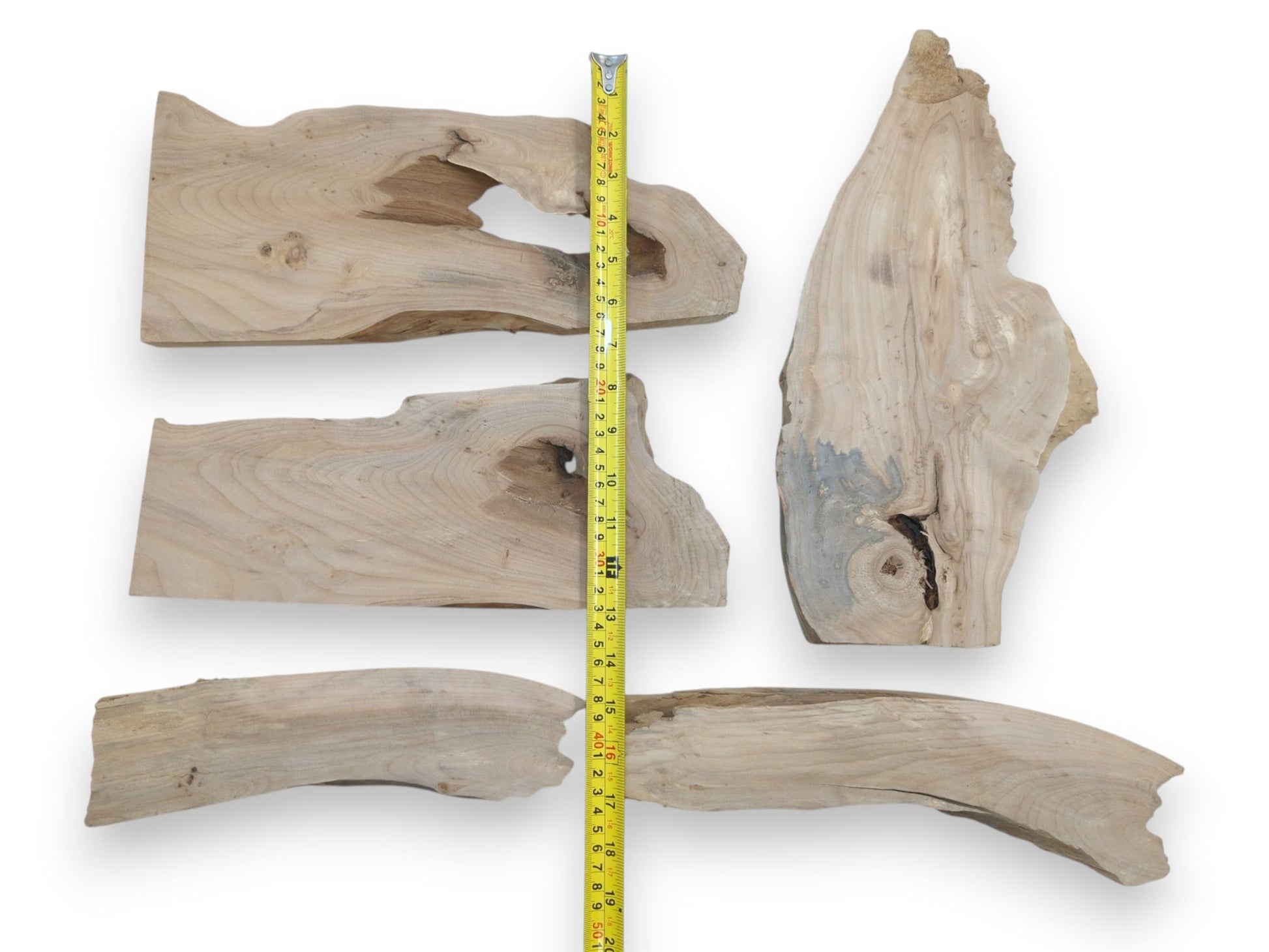 Five natural alder wood slabs with live edges, prominent knots, and varied wood grain.
