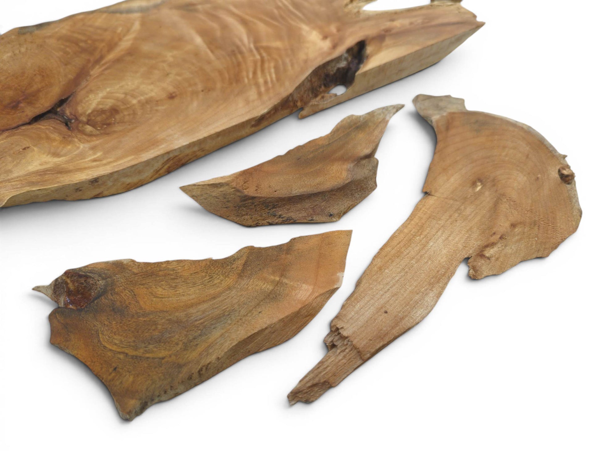 Four natural edge alder wood pieces with visible grain and knots on a white background.