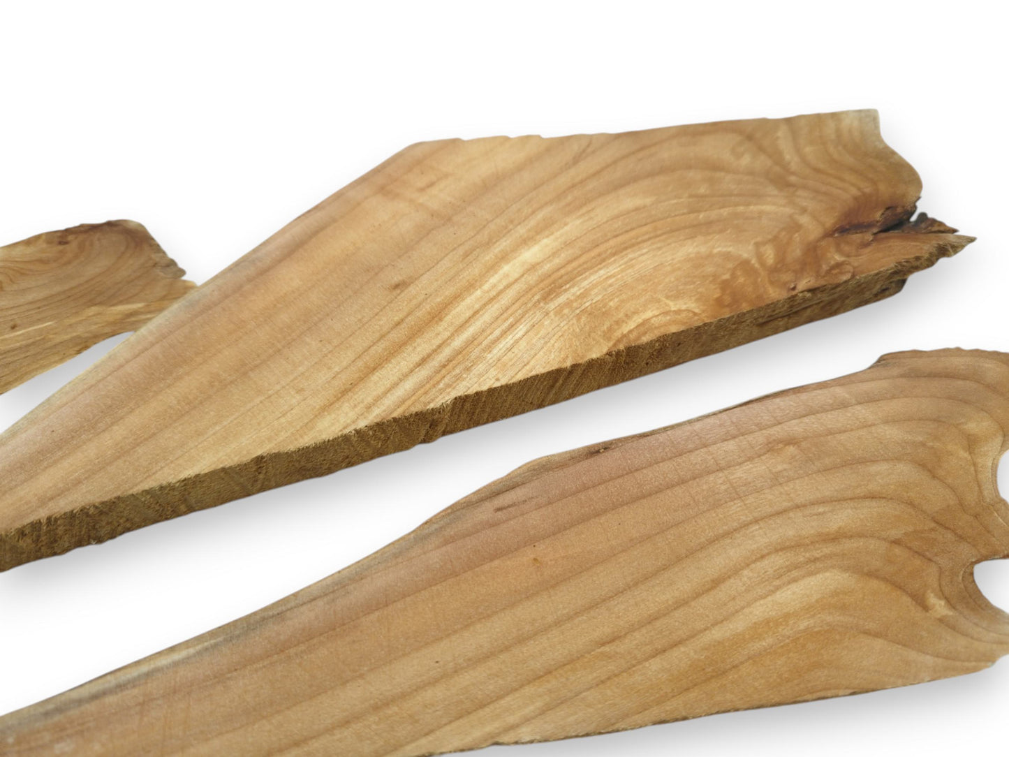 Three light brown alder wood pieces with natural wavy edges and visible grain on white.