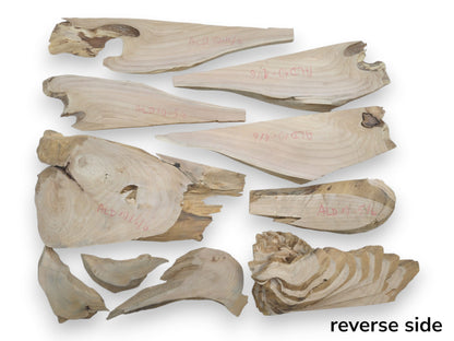 A collection of light-colored alder wood pieces with natural edges and visible grain patterns.