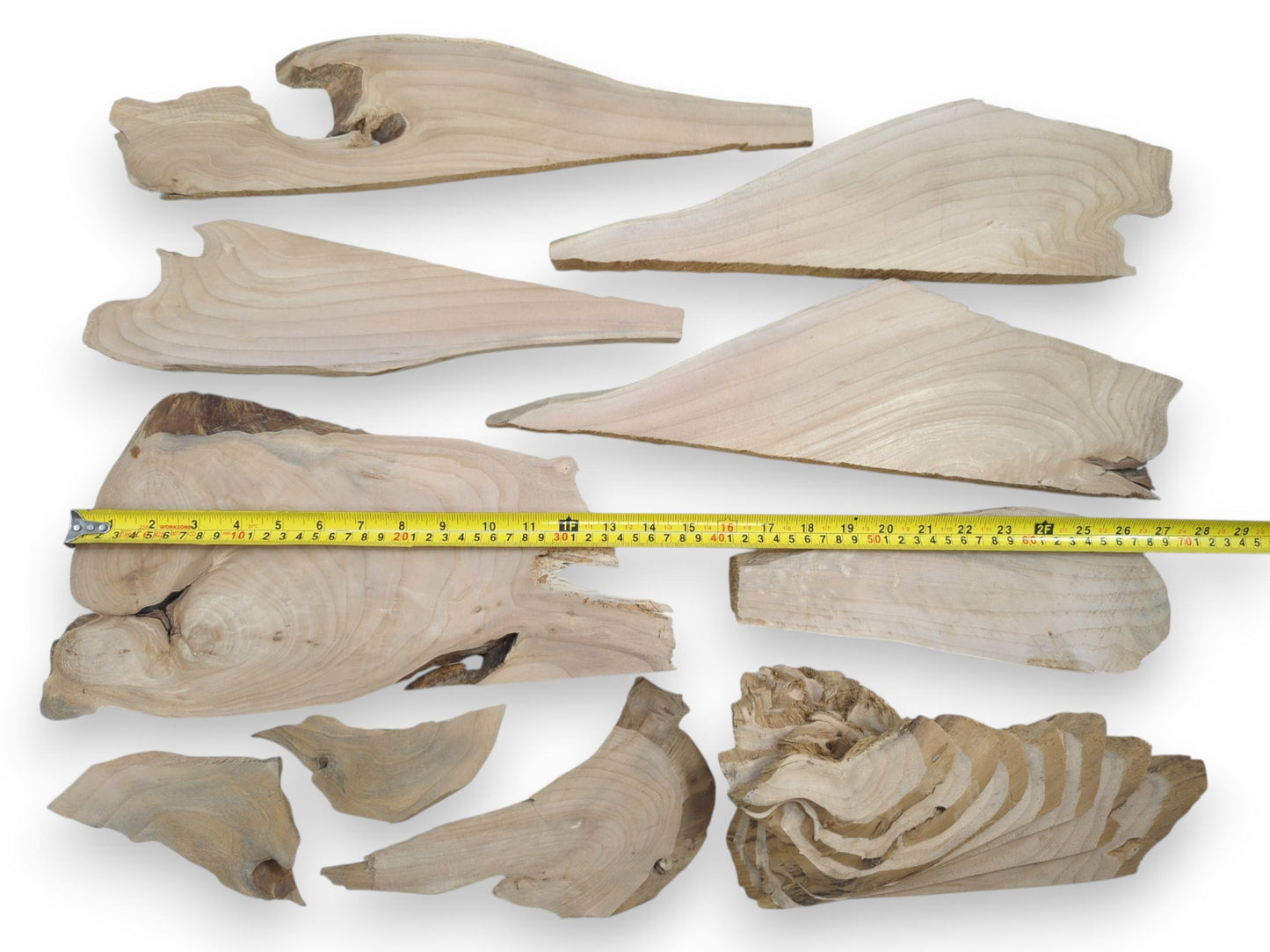 Various light-colored alder wood pieces with natural edges, visible grain, and some knots.