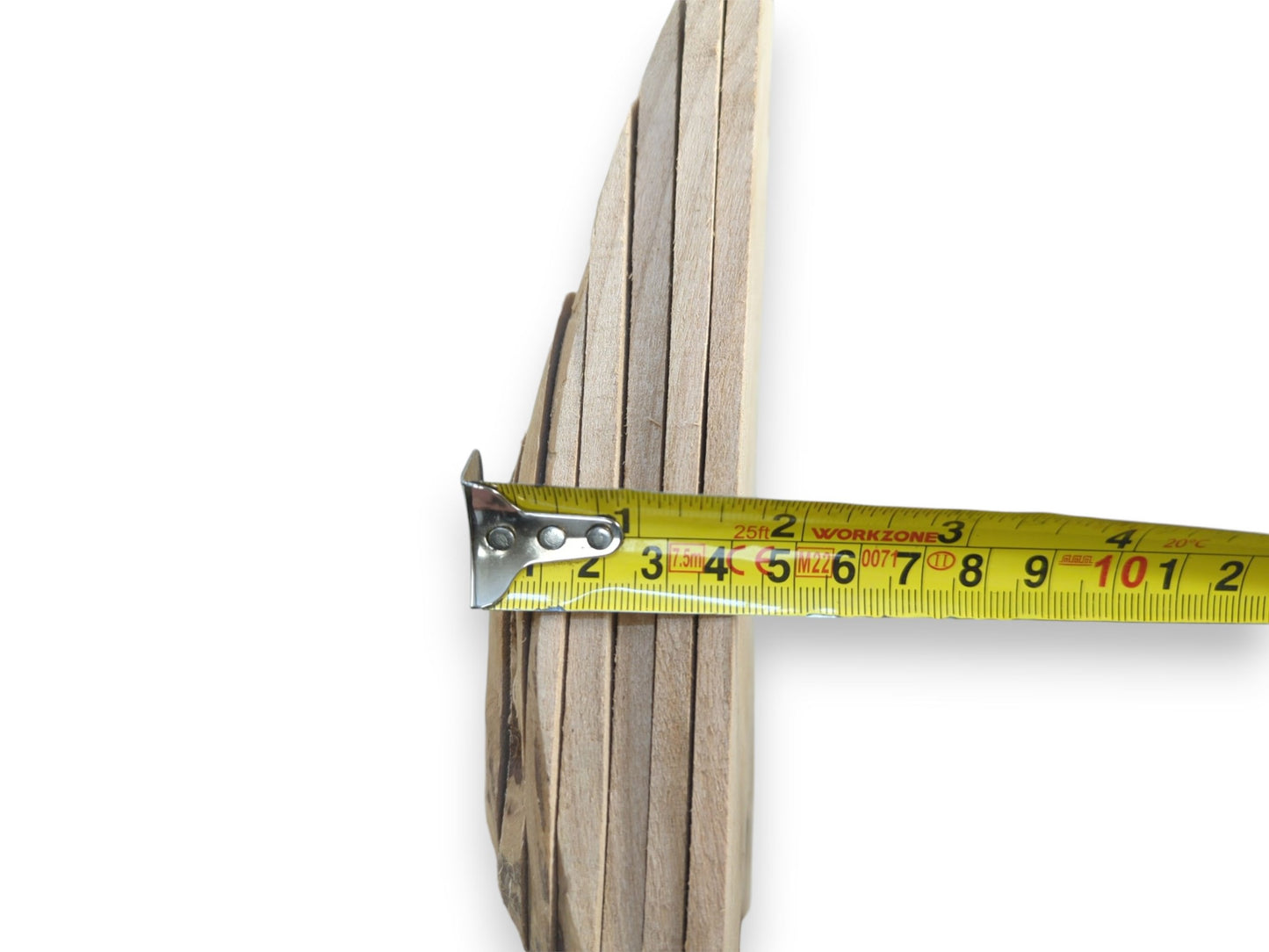 A stack of light-colored alder wood pieces with natural edges, measured by a yellow tape.