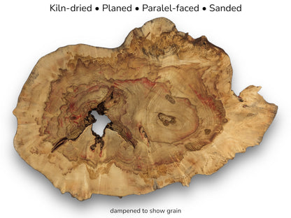 Irregular wood slice showing red grain and central hole, with text listing kiln-dried and sanded status.