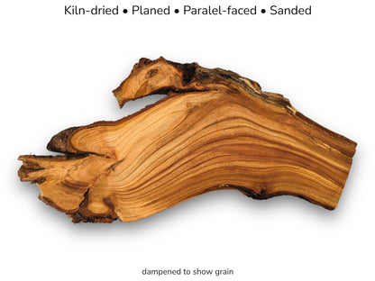 A gnarled cherry root section with wavy, contoured grain lines and a dark, rugged edge.