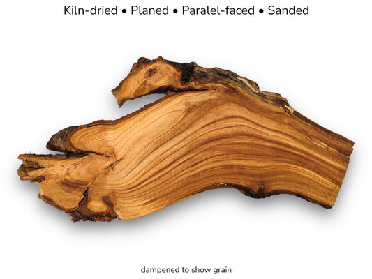 A gnarled cherry root section with wavy, contoured grain lines and a dark, rugged edge.