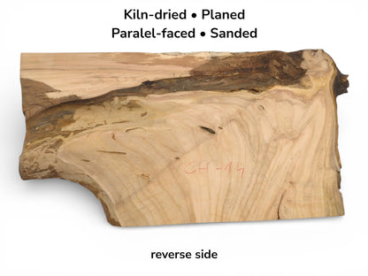 The reverse side of a cherry wood blank, showing its light-toned grain, dark edge, and preparation text.