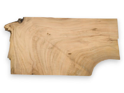 A full view of a wild cherry lumber blank, showing its organic shape and flowing grain.