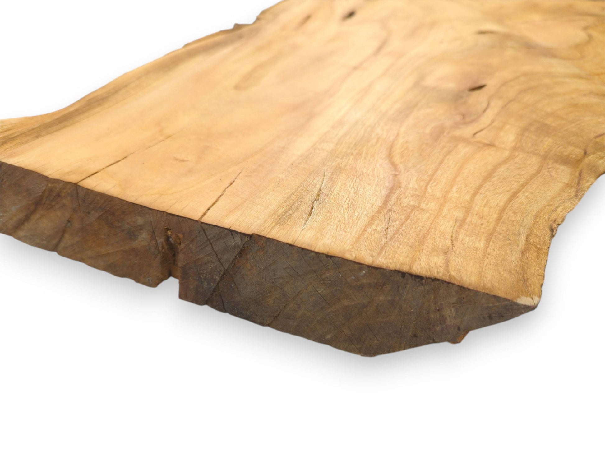 A close-up view highlighting the thick, rough-sawn edge and smooth, light-toned surface of a wood slab.