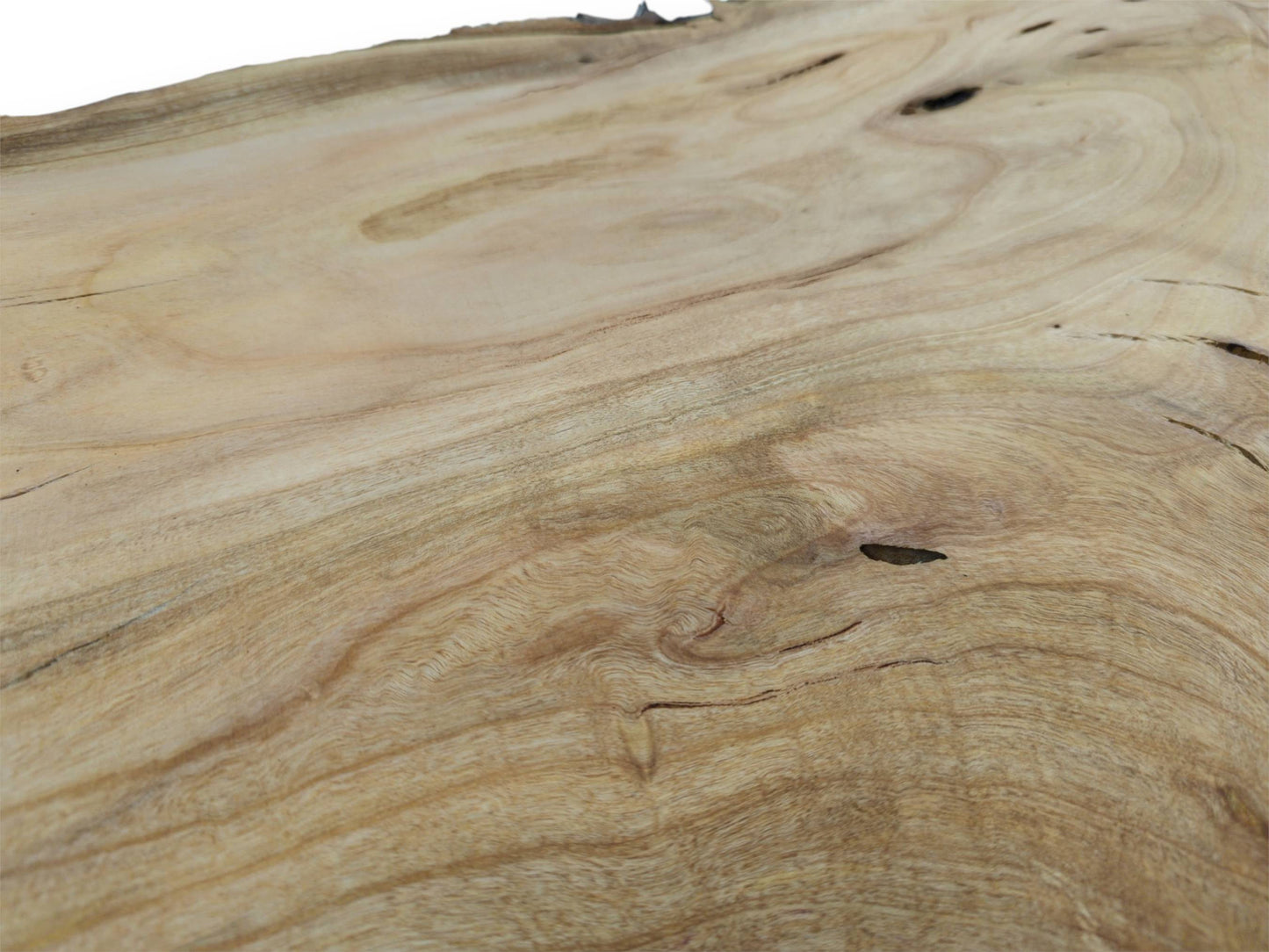 A detailed, low-angle view across a cherry wood slab showing smooth, swirling grain and knots.