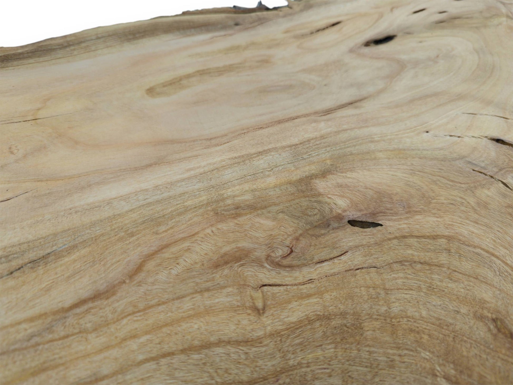 A detailed, low-angle view across a cherry wood slab showing smooth, swirling grain and knots.