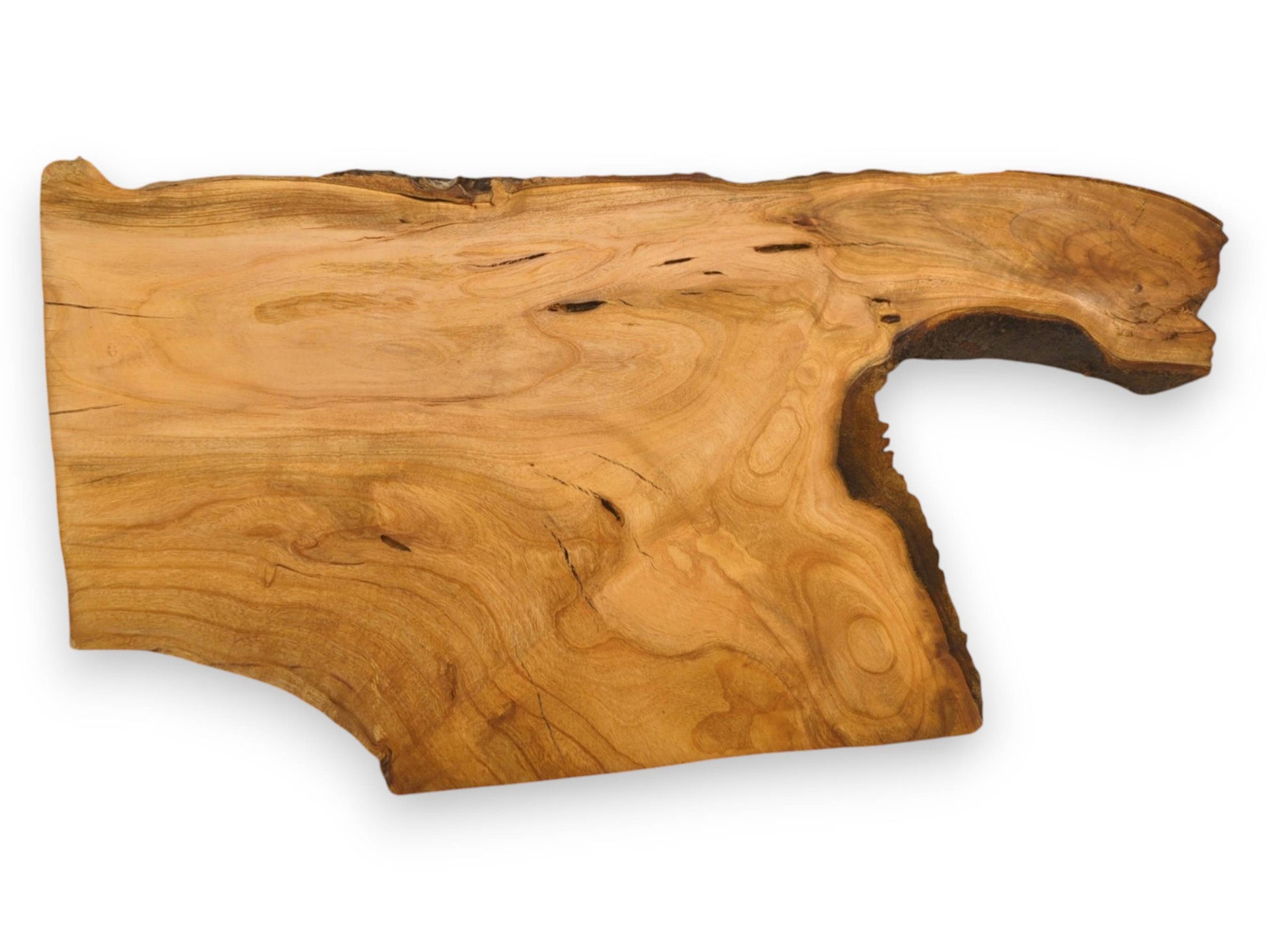 An unfinished cherry slab with wavy grain patterns and a distinctive protrusion along its natural live edge.