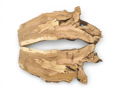 Two corresponding halves of a raw cherry slab display their irregular live edges and varied grain.
