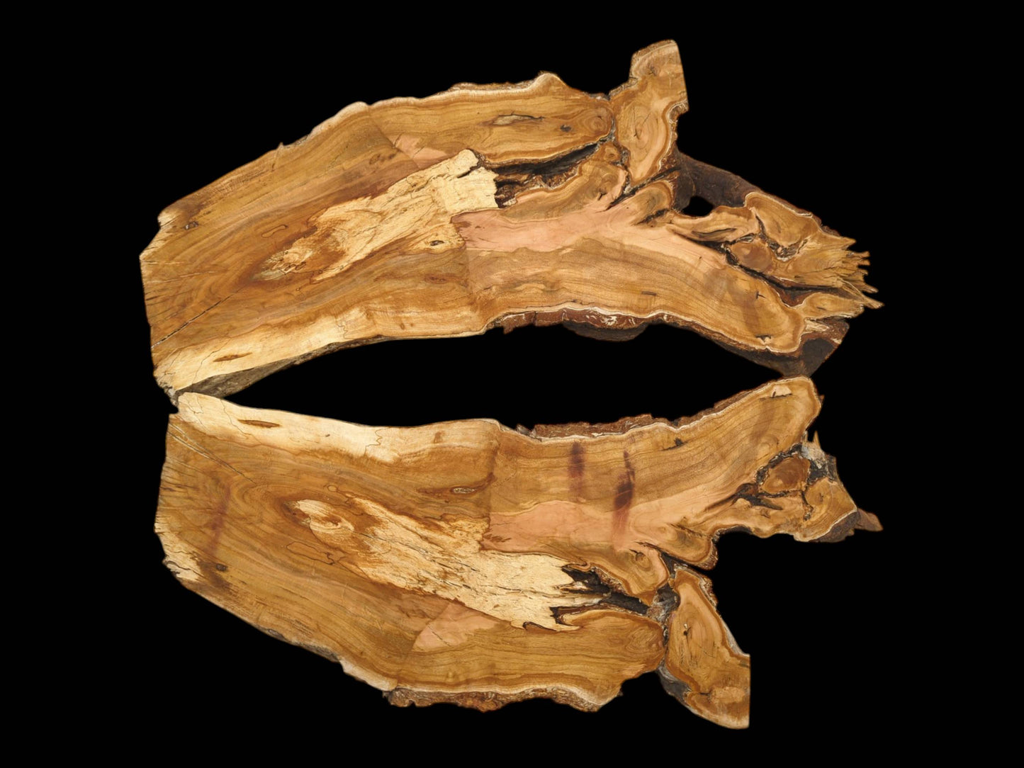 Two matching halves of a cherry wood slab laid open, revealing a symmetrical, highly figured grain.
