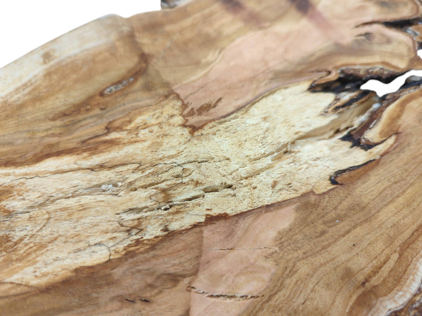 A macro shot contrasting the smooth wood grain with a coarse, pitted section of the cherry slab.