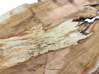 A macro shot contrasting the smooth wood grain with a coarse, pitted section of the cherry slab.