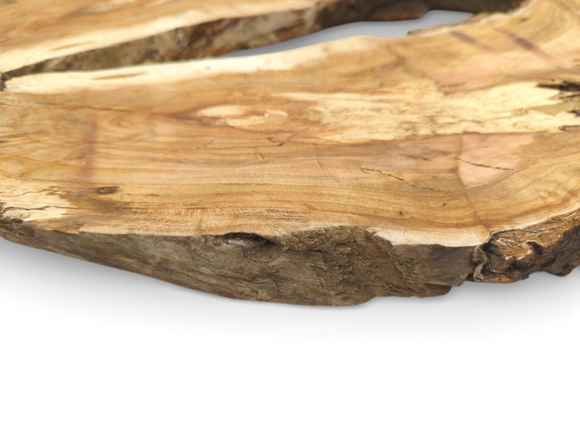 A detailed, low-angle view contrasting the rough live edge with the slab's sanded, grained surface.
