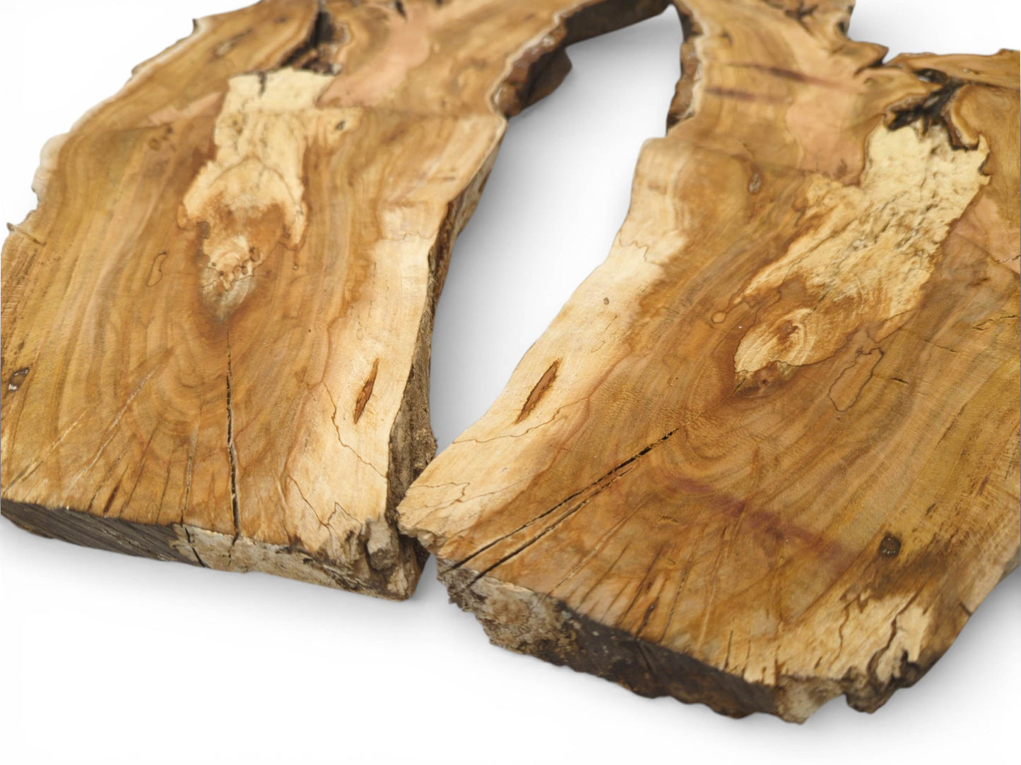 Two halves of a raw cherry wood slab showing the grained surface and deep natural cracks.