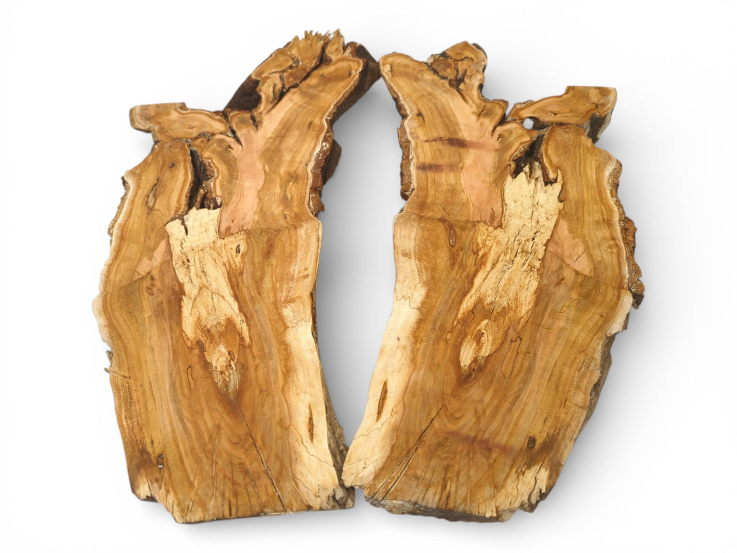 An overhead perspective of a single wood slab split into two halves, revealing intricate grain.