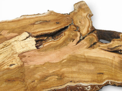 An overhead view detailing a cherry wood slab's swirling grain, pinkish hues, and large natural void.