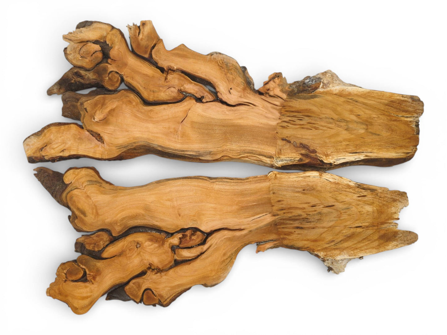 An overhead shot captures two complementary wood sections with knotted forms on one end and straight cuts.