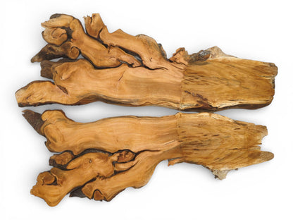 An overhead shot captures two complementary wood sections with knotted forms on one end and straight cuts.