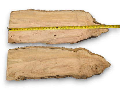 Two wild cherry live edge slabs, with a yellow tape measure showing the top slab's length.